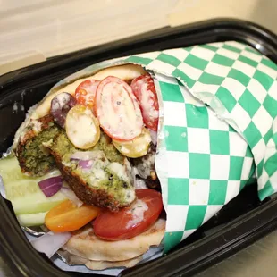 a sandwich wrapped in paper