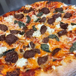 a pizza with meat and cheese