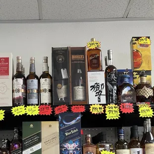 a shelf full of liquor bottles