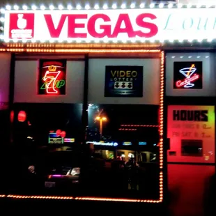 a neon sign in front of a restaurant