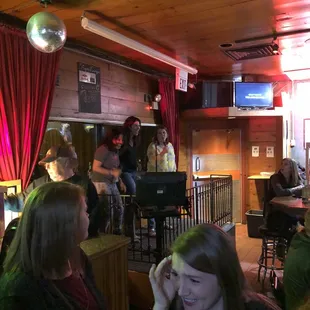a group of people sitting at a bar