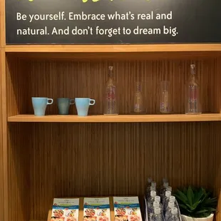 a shelf with books and water bottles