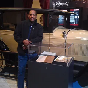 My dad standing by a car in the museum section