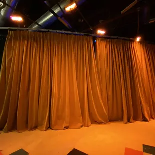 The set was hidden by this curtain.