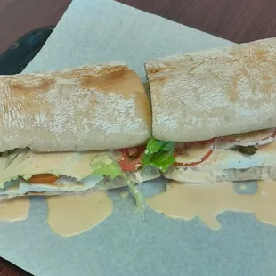 Giant Torta with Grilled Asada Meat, Melted Cheese, Sour Cream Lettuce, Tomatoes, Avocado Sauce, Jalapenos and Specialty Sauce