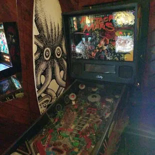 a surfboard and pinball machine