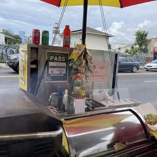 a veggie stand under an umbrella