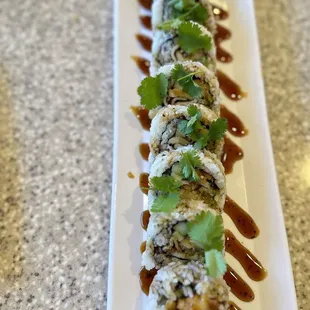 a plate of sushi with sauce