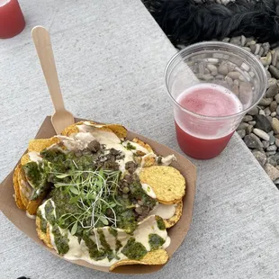 a plate of nachos and a drink