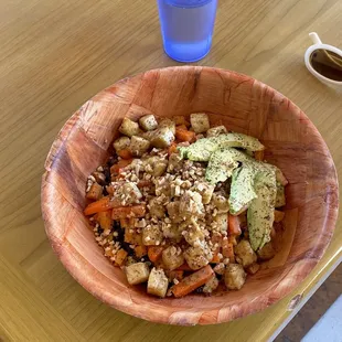 Quinoa, Black Bean, Sautéed Tofu, Carrots, Sweet potato, Zucchini, Avocado, mixed nuts, Thia Peanut sauce