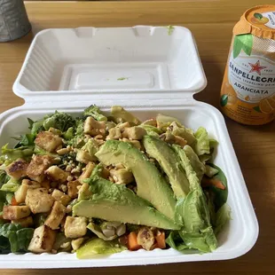 Customized bowl with tofu, quinoa, spring mix, veggies, avocado and curry &amp; Serrano cilantro dressing.