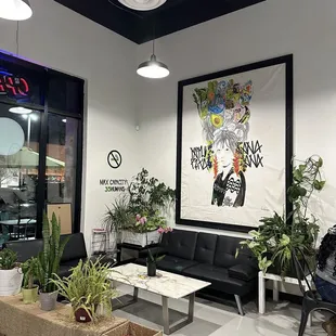 a living room with a couch, coffee table, and plants