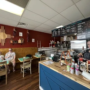 two people sitting at a table in a restaurant