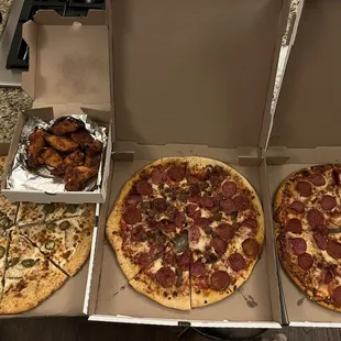 Chicken/jalapeños (Alfredo sauce), meat lovers, pepp/canadian bacon and buffalo wings in the back