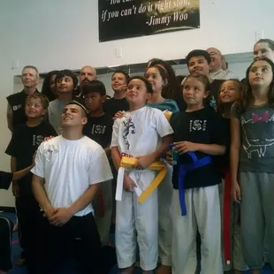 Kids earning a belt at a recent ceremony and barbecue