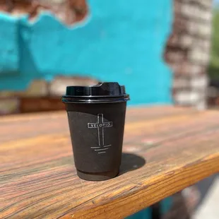 a cup of coffee on a wooden table