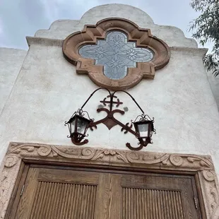 a stained glass window above a wooden door