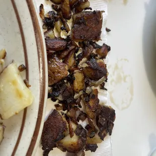 Potatoes and onions burnt down to carbon. If you care about your health don't eat this cr*p