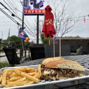 Philly cheesesteak sandwich with fries