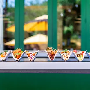 a row of tacos on a counter