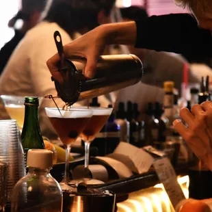a bartender pouring a drink