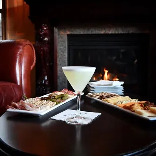 two plates of food and a glass of wine