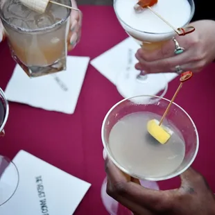 a group of people holding cocktails