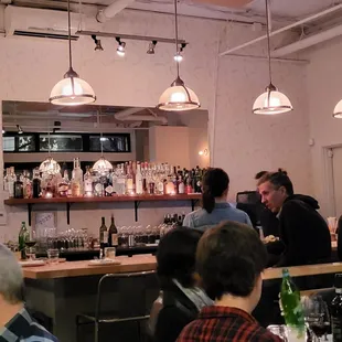 a group of people sitting at a bar