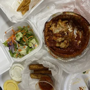 Lasagna, mozzarella sticks, salad, and fries.