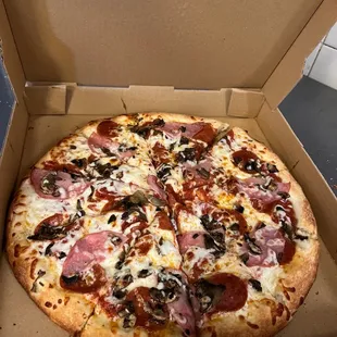 Large pizza with one free topping for only $11.99 Monday- Thursday. *** This pizza has pepperoni, Canadian bacon, and mushrooms. Yum!! ***