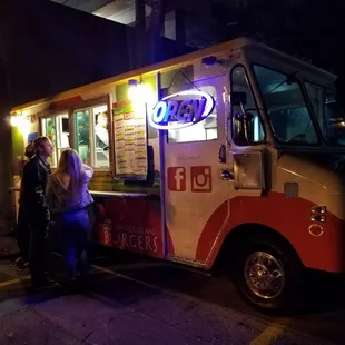 a food truck with neon lights