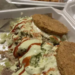 meat, cheese, and sauce in a styrofoam container