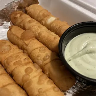 a bowl of dip and a roll