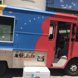 a colorful food truck parked in front of a building