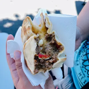 a person holding a sandwich