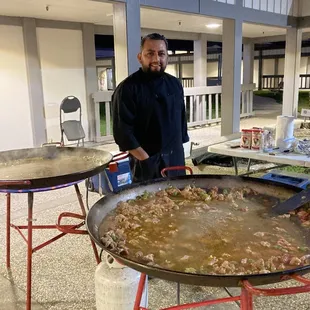 Equardo stood out in the cold weather preparing the paella