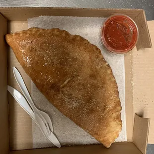 a piece of pizza in a box