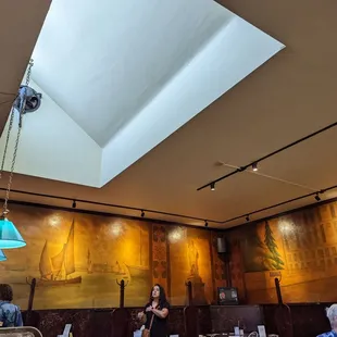 a woman standing in the middle of a dining room