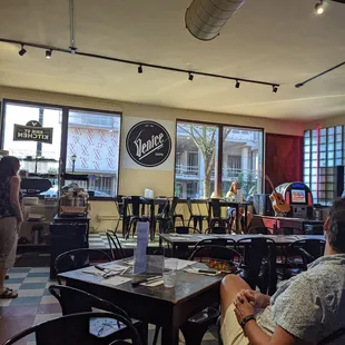 people sitting at tables in a restaurant