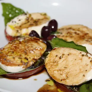 The Mozzarella Caprese was made with vine-ripened tomatoes, fresh mozzarella, basil, and olives.