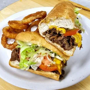 two sandwiches on a plate with onion rings