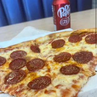 a slice of pizza with pepperoni on it