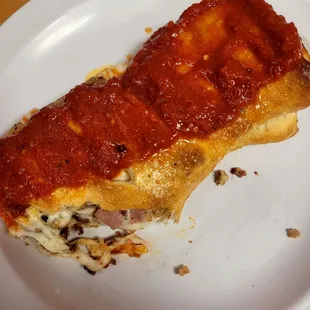 Hawaiian chicken stromboli with marinara sauce added on top