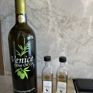 A large bottle of olive oil ($38) and 2 tiny balsamics at $5 each