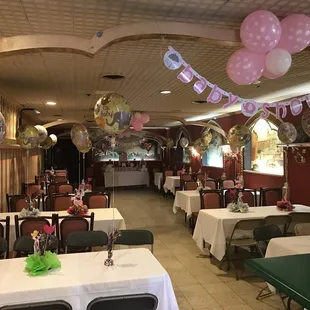 a dining room with tables and balloons