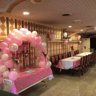 a dining area with balloons and tables