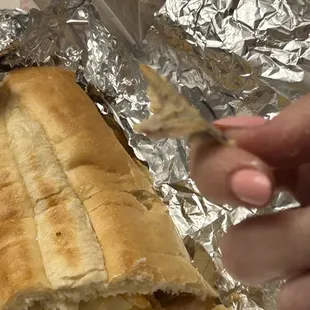 a hand holding a piece of bread