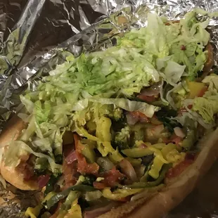 a hot dog covered in lettuce