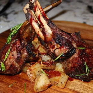 The Rack of Lamb was served atop potatoes. The Rack of Lamb was gorgeous in presentation &amp; taste - the meat was outrageously succulent.