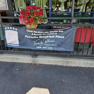 Sign near entrance. It is a storefront in a strip mall.